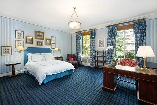 a bedroom with a bed table and a window