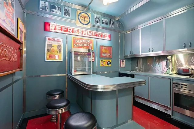 a dining room with furniture a fireplace and a chandelier