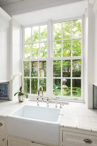 a kitchen with kitchen island granite countertop a sink a stove and a wooden floors
