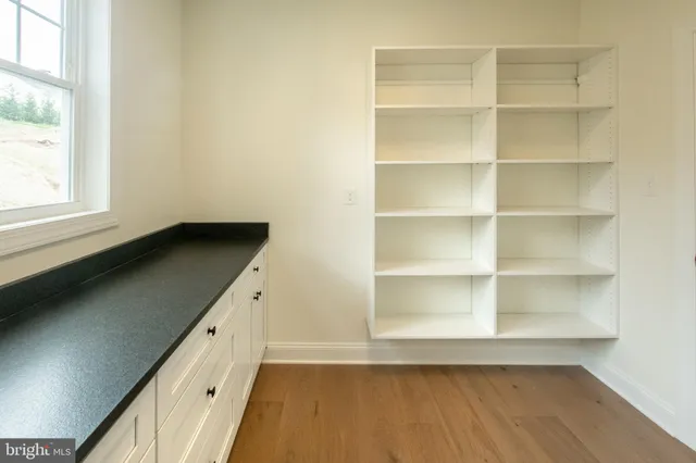 an empty room with a empty space and windows