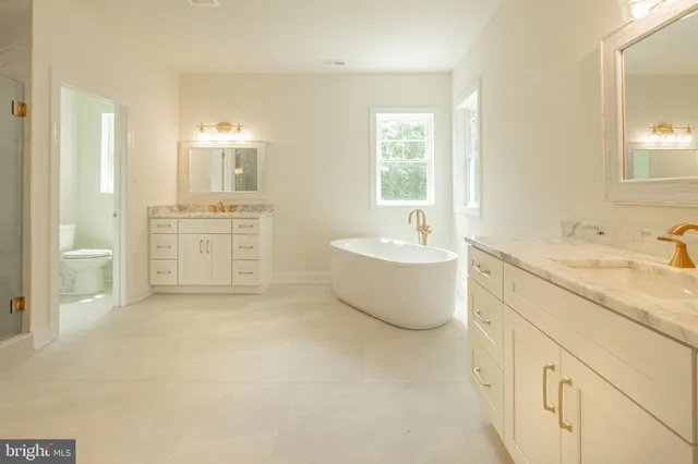 a bathroom with a sink mirror and a bathtub