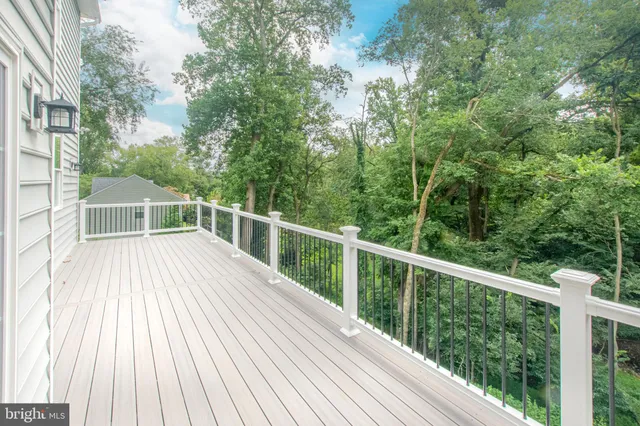 a view of balcony with wooden floor and fence
