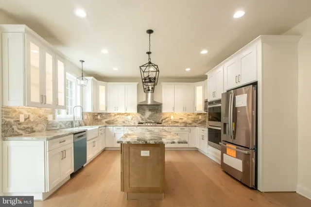 a large kitchen with kitchen island granite countertop lots of counter top space