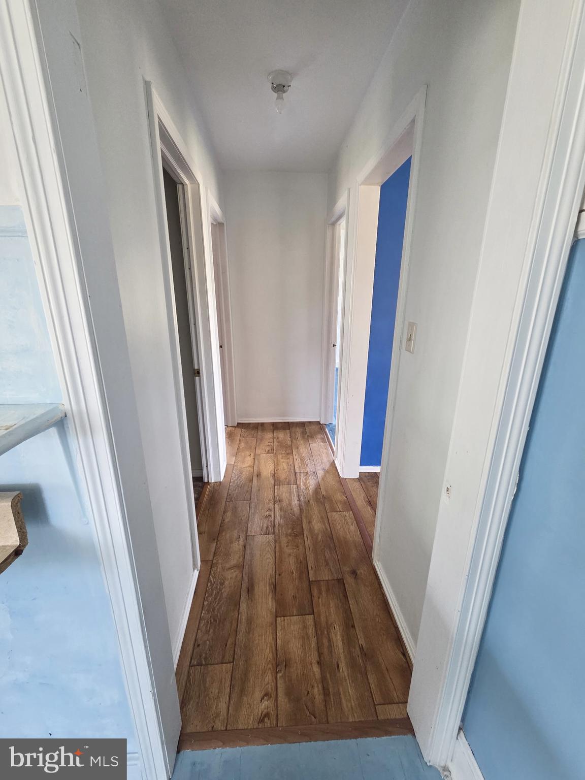 2539 Toddville Road Toddville, MD 21672 - Photo 23 of 31 a view of a hallway with wooden floor and staircase