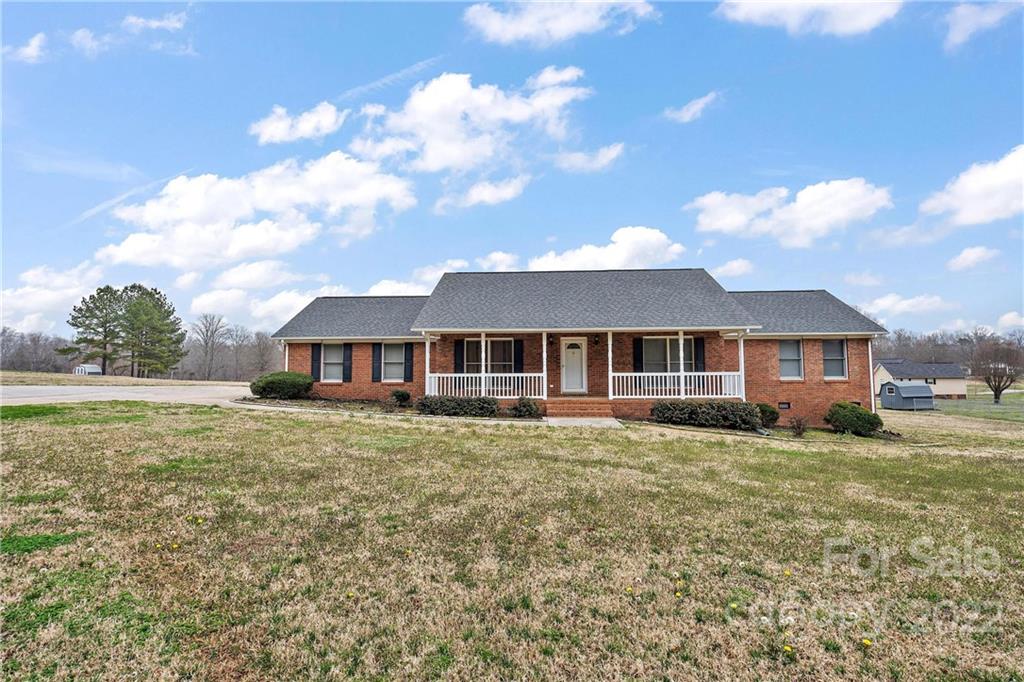 585 Windy Hill Road York, SC 29745 - Photo 1 of 38 a front view of a house with a garden