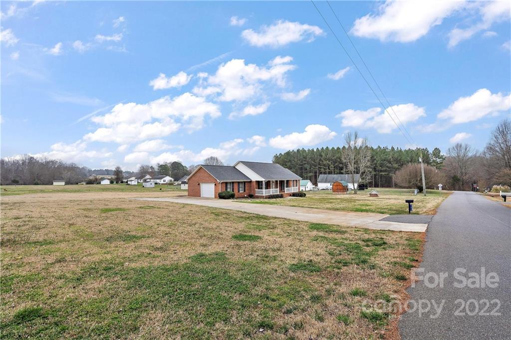 585 Windy Hill Road York, SC 29745 - Photo 2 of 38 a view of a house with a yard and lake view