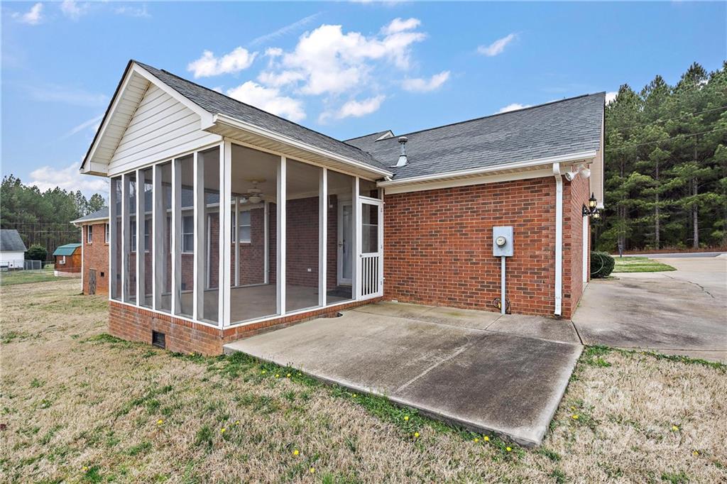 585 Windy Hill Road York, SC 29745 - Photo 33 of 38 a view of a house with a small yard and floor to ceiling window
