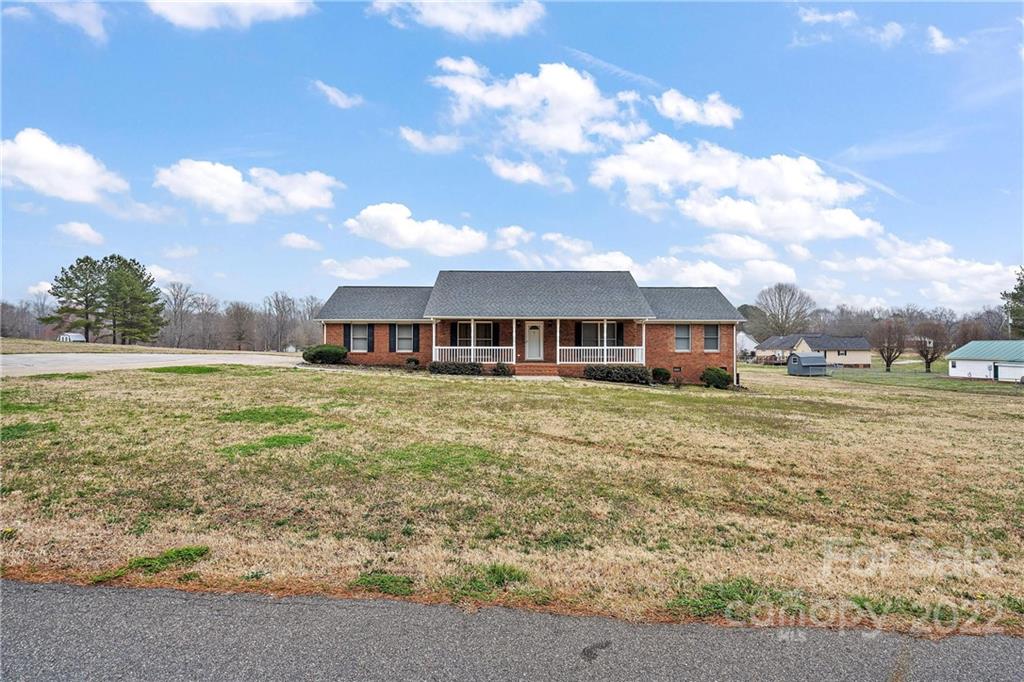 585 Windy Hill Road York, SC 29745 - Photo 4 of 38 a front view of a house with a garden