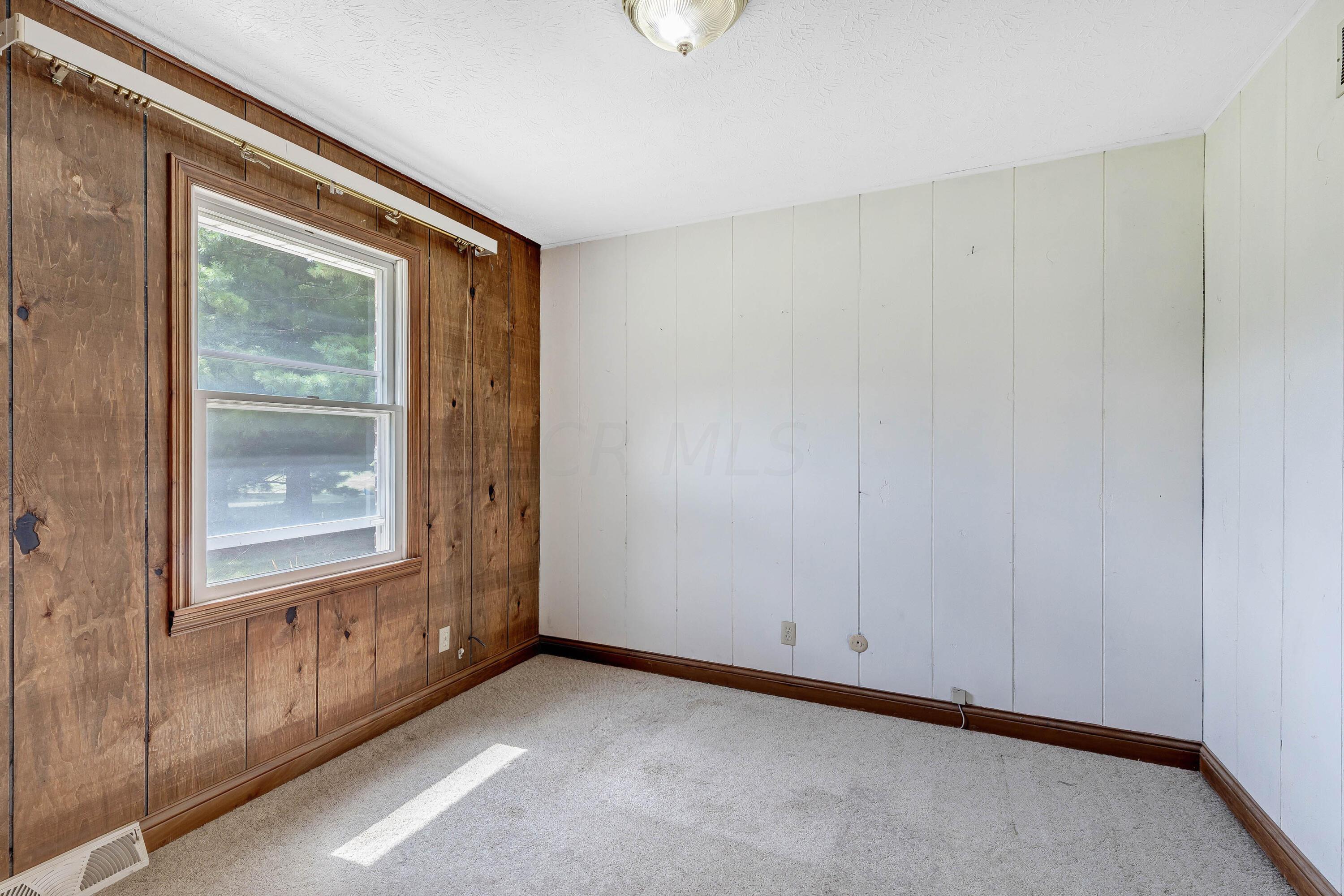8558 Morris Road Hilliard, OH 43026 - Photo 16 of 74 • Tan carpet • Panelled walls • Ceiling light • Open closet