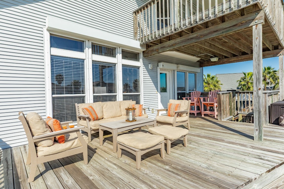1319 Coral Way Tiki Island, TX 77554 - Photo 14 of 45 a outdoor space with patio the couches and a dining table with wooden floor and fence