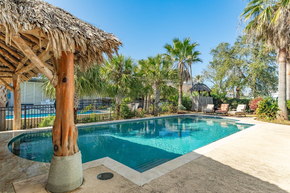 1319 Coral Way Tiki Island, TX 77554 - Photo 19 of 45 a view of a swimming pool with a patio