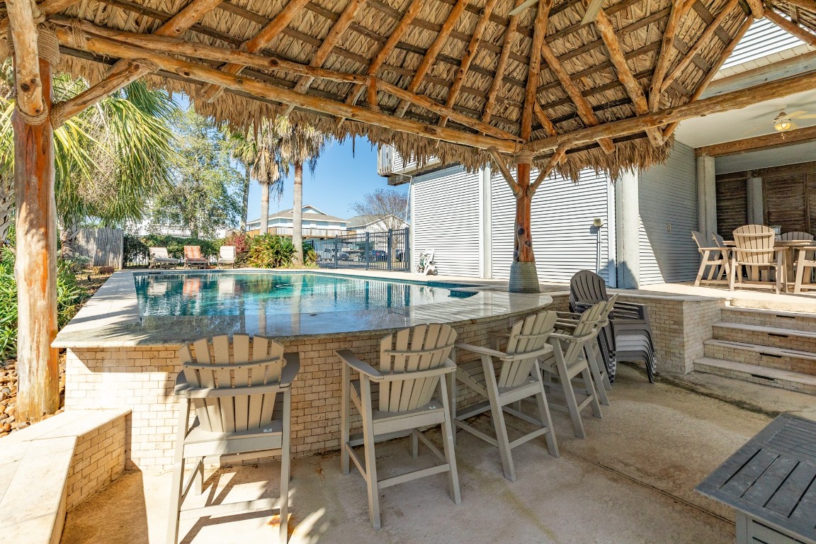 1319 Coral Way Tiki Island, TX 77554 - Photo 21 of 45 a outdoor dining space with furniture and outdoor view