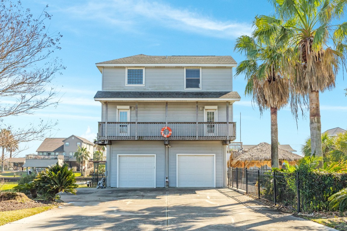 1319 Coral Way Tiki Island, TX 77554 - Photo 28 of 45 a front view of a house with a yard