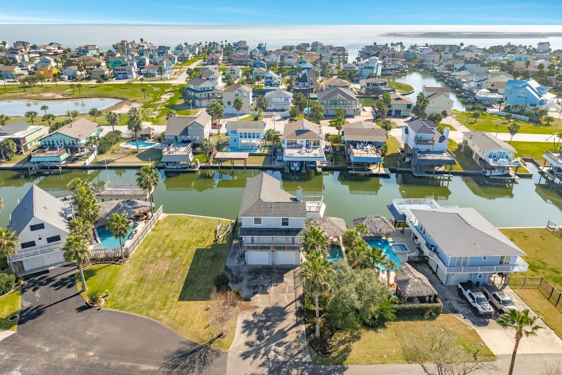 1319 Coral Way Tiki Island, TX 77554 - Photo 3 of 45 an aerial view of a residential building with outdoor space lake view and mountain view