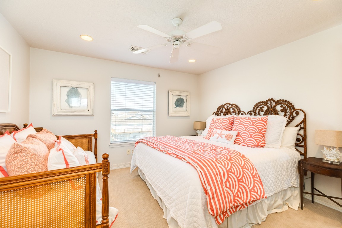 1319 Coral Way Tiki Island, TX 77554 - Photo 42 of 45 a bedroom with a bed and wooden floor