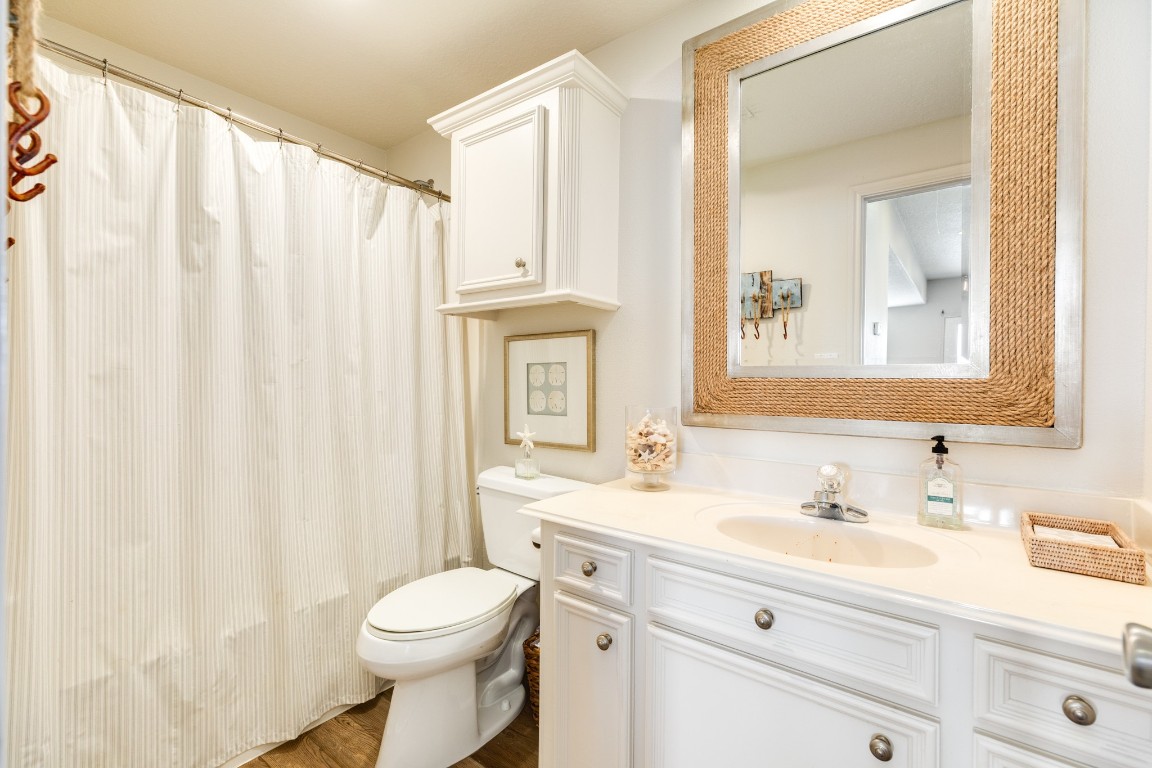 1319 Coral Way Tiki Island, TX 77554 - Photo 45 of 45 a bathroom with a sink a toilet and a mirror