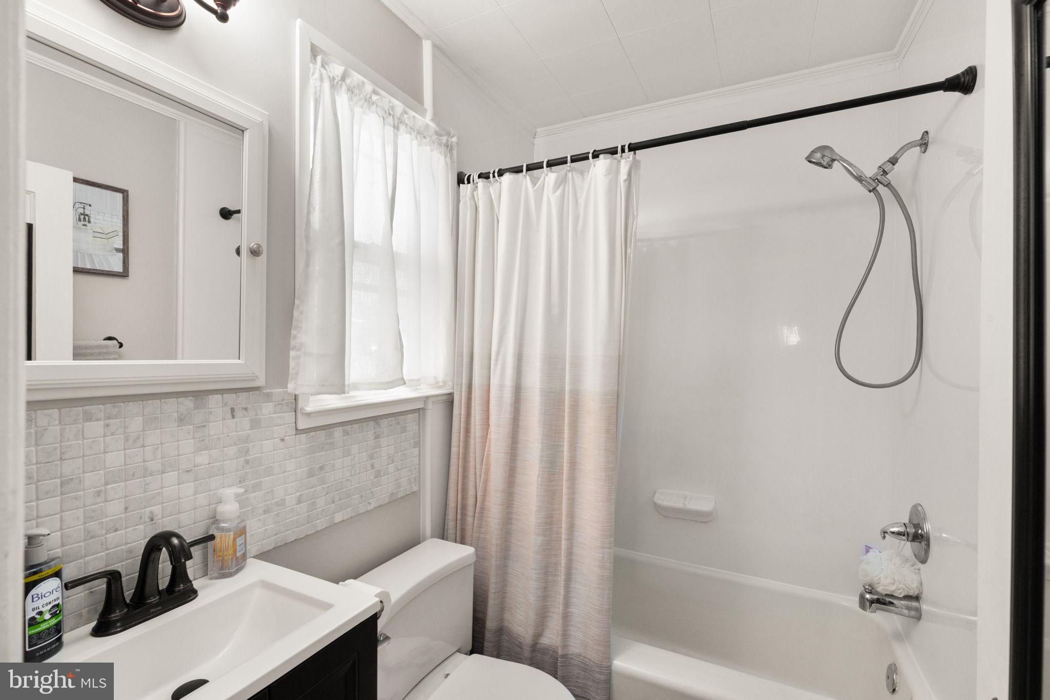 2912 Church Baltimore, MD 21234 - Photo 17 of 31 a bathroom with a sink and a shower curtain