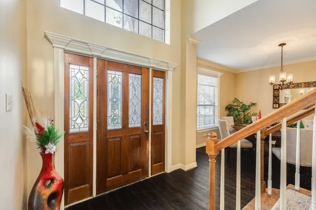 a view of an entryway with wooden floor and stairs