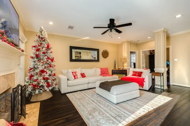 a living room with furniture and flowers