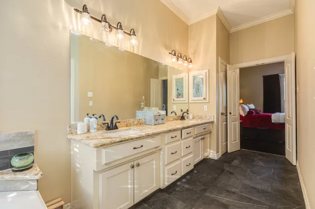 a en suite bathroom with a double vanity sink a mirror and a shower