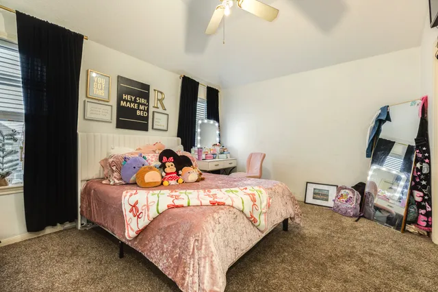 an empty room with furniture and windows