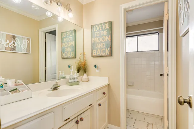 a view of a house with a big yard and large trees