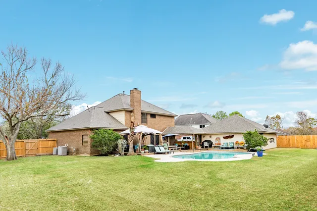 an outdoor space with pool and furniture