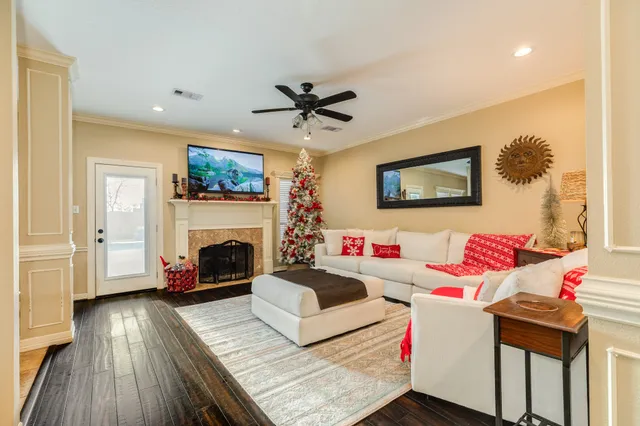 a living room with furniture a flat screen tv and a fireplace