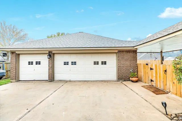 a view of a house with wooden fence