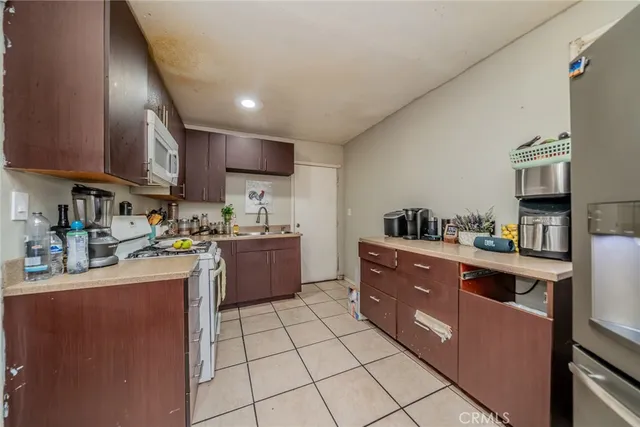 a kitchen with stainless steel appliances granite countertop a sink counter space cabinets and a counter top space