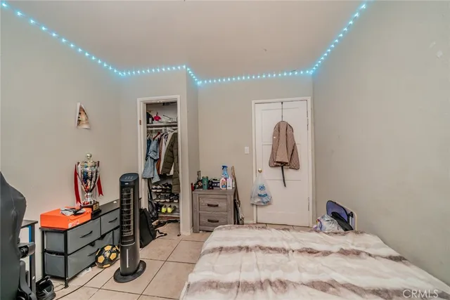 a bedroom with a bed and a bookshelf