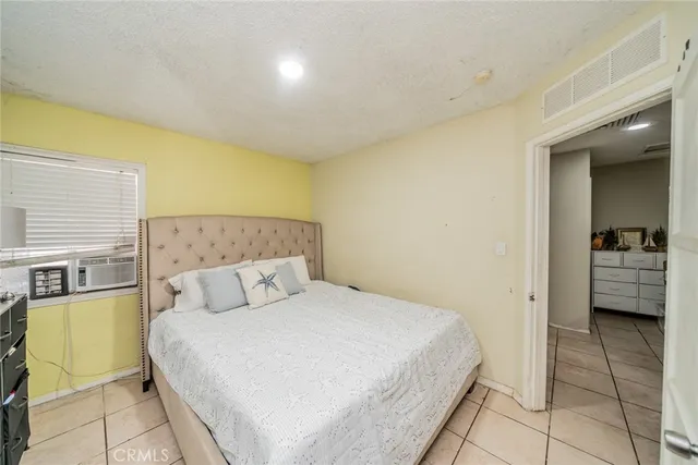 a bedroom with a bed a couch and dresser