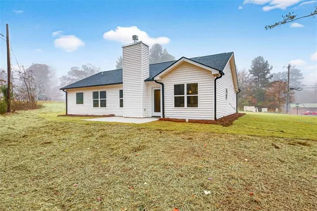 a view of a house with a yard and garage