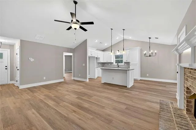 a view of a kitchen with wooden floor and a kitchen