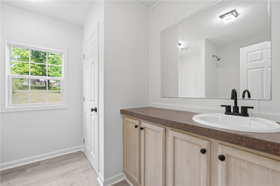 112 Sir Francis Drake Way Liberty, SC 29657 - Photo 19 of 42 This bright bathroom features a spacious vanity and ample natural light from the window.