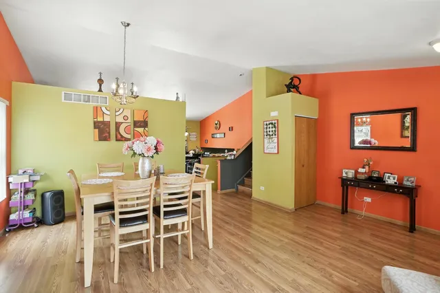 a view of a dining room with furniture and wooden floor