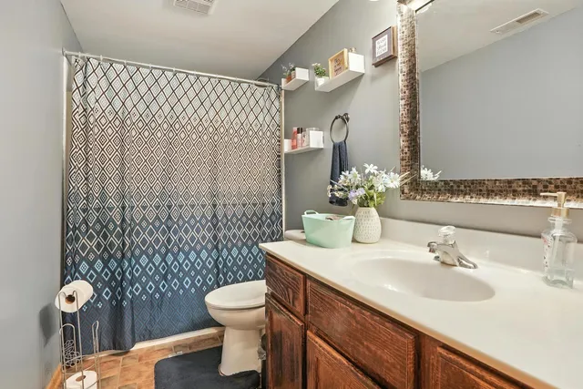 a bathroom with a sink toilet and shower