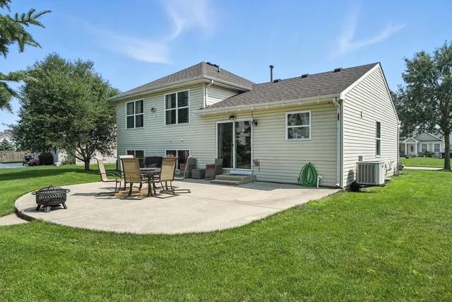 a view of a house with backyard sitting area and garden