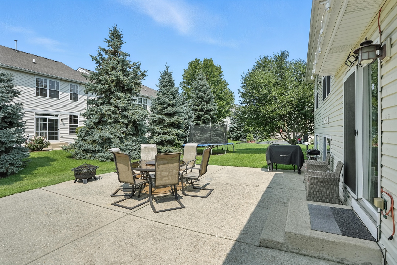 1986 Brimstone Road Romeoville, IL 60446 - Photo 22 of 32 a view of a patio with table and chairs potted plants and a palm tree