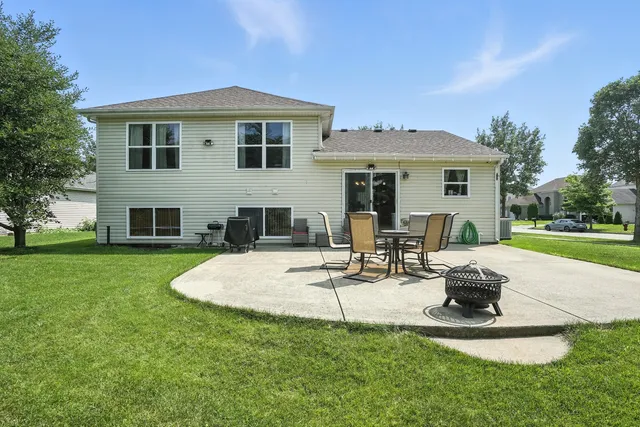 a view of a house with backyard sitting area and garden