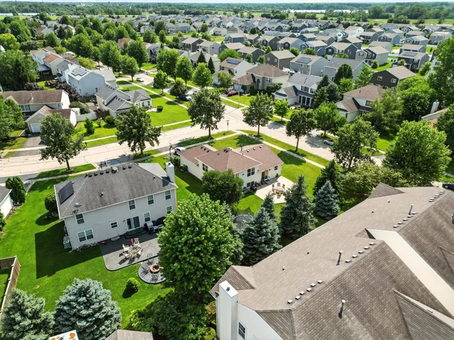 an aerial view of residential houses with outdoor space