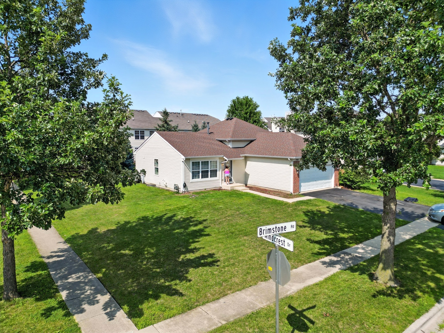 1986 Brimstone Road Romeoville, IL 60446 - Photo 30 of 32 a view of a white house with a big yard plants and large trees