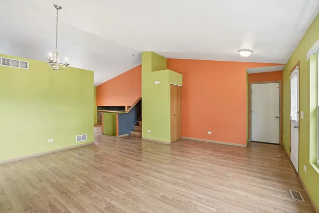 a view of a room with wooden floor