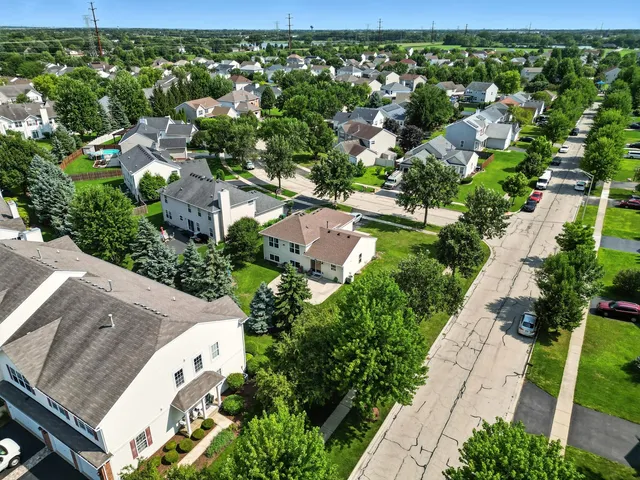 a view of a house with swimming pool and a yard