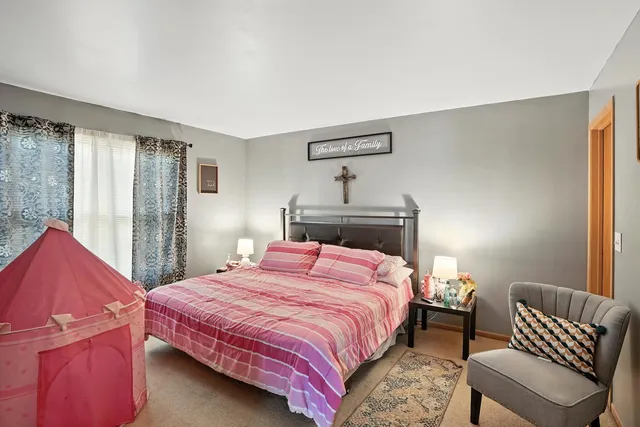 a bedroom with a bed and a chair