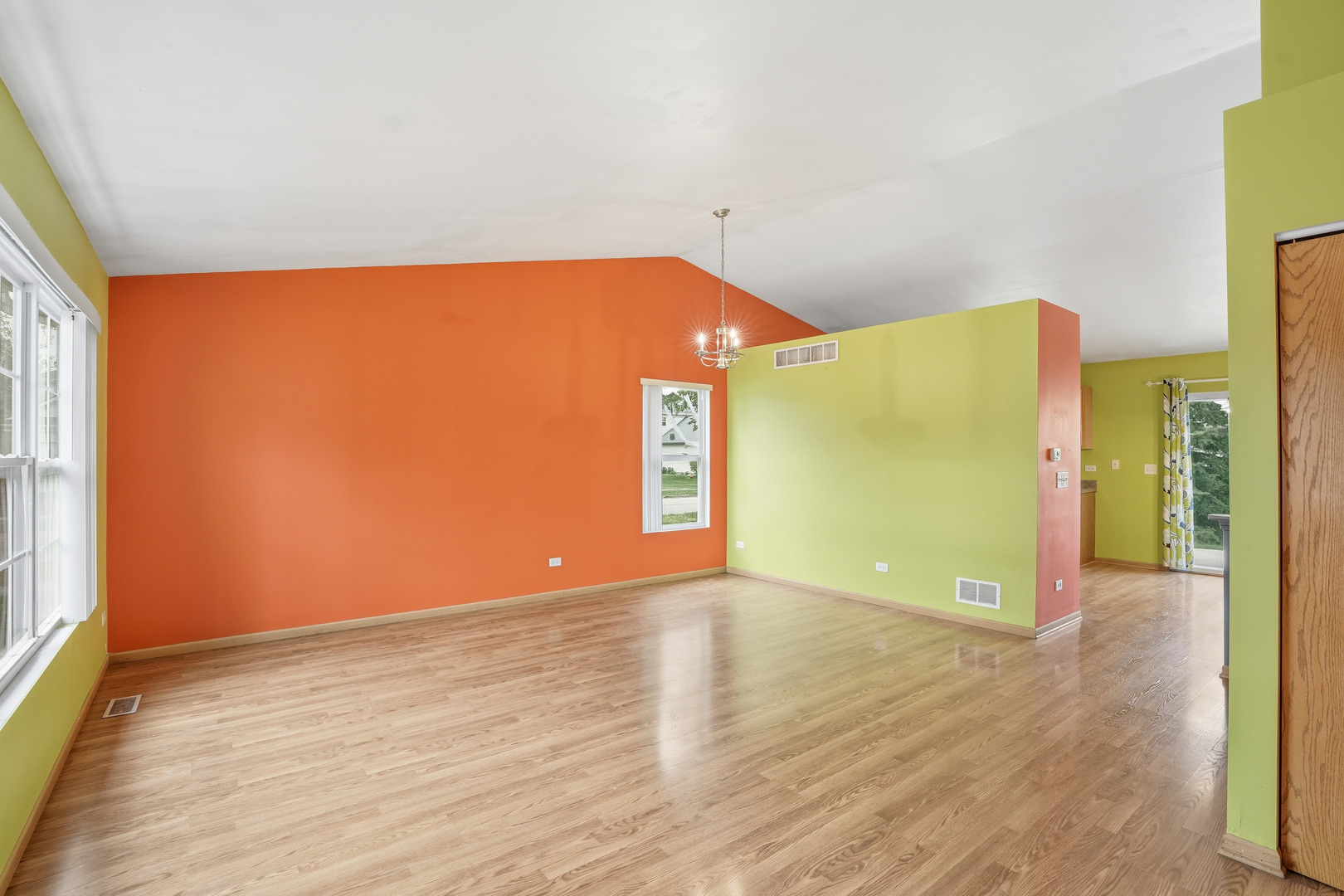 1986 Brimstone Road Romeoville, IL 60446 - Photo 4 of 32 a view of an empty room with wooden floor and a window