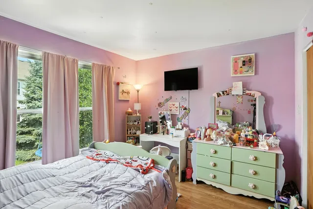 a bedroom with a bed and a flat screen tv