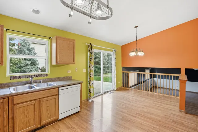 a spacious bathroom with a double vanity sink a mirror and a large window