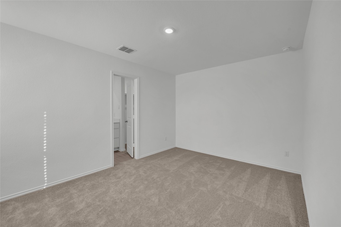309 Marty Allen Loop Jarrell, TX 76537 - Photo 13 of 30 Empty room with light colored carpet and baseboards