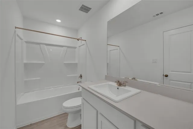 a view of a field and a building in the background